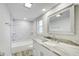 Bathroom featuring a shower and tub combo and modern vanity with marble countertop at 9497 122Nd Way, Seminole, FL 33772