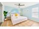 Bright bedroom featuring a comfy bed, cheerful wall decorations, and a ceiling fan at 9497 122Nd Way, Seminole, FL 33772
