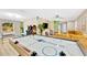 Bright game room with air hockey, arcade games, and a comfortable yellow sectional sofa at 9497 122Nd Way, Seminole, FL 33772