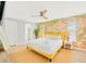 Stylish main bedroom with a bright yellow bedframe and vibrant floral wallpaper at 9497 122Nd Way, Seminole, FL 33772
