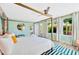 Bright main bedroom featuring a four-poster bed, colorful decor, and ample natural light at 9497 122Nd Way, Seminole, FL 33772