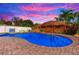 Private pool with a tiki umbrella surrounded by lush tropical landscaping at 9497 122Nd Way, Seminole, FL 33772