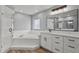 Bathroom with large bathtub, glass shower, and vanity at 1438 Mclin Dr, Plant City, FL 33565