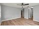 Neutral bedroom featuring wood-look floors and multiple entryways at 1438 Mclin Dr, Plant City, FL 33565