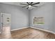 Sunlit bedroom boasts hardwood floors, neutral walls, and a view of the pool at 1438 Mclin Dr, Plant City, FL 33565