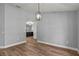 Open dining area with hardwood floors, pendant lighting, and access to kitchen at 1438 Mclin Dr, Plant City, FL 33565