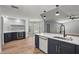 Open-concept kitchen featuring a wine fridge, white countertops and stainless steel appliances at 1438 Mclin Dr, Plant City, FL 33565