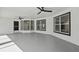 Bright living room with large windows and contemporary ceiling fans at 1438 Mclin Dr, Plant City, FL 33565