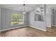 Bright living area featuring hardwood floors, stylish lighting and large window at 1438 Mclin Dr, Plant City, FL 33565