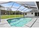 Sparkling screened-in pool with a large backyard and clear blue skies at 1438 Mclin Dr, Plant City, FL 33565