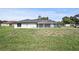 Back of home with a screened pool and expansive backyard at 1438 Mclin Dr, Plant City, FL 33565