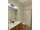 Bathroom features a shower/tub combo, and vanity with light wood cabinets at 5864 Fishhawk Ridge Dr, Lithia, FL 33547