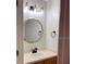 Bathroom features a large vanity, round mirror, and updated light fixtures at 5864 Fishhawk Ridge Dr, Lithia, FL 33547