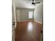 A cozy bedroom featuring hardwood floors, a ceiling fan, and a window with natural light at 5864 Fishhawk Ridge Dr, Lithia, FL 33547