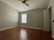 Neutral bedroom with wood floors, ceiling fan, and closet space at 5864 Fishhawk Ridge Dr, Lithia, FL 33547