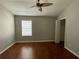 Well-lit bedroom featuring ceiling fan, closet, and wood floors at 5864 Fishhawk Ridge Dr, Lithia, FL 33547