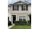 Charming townhome exterior with neutral paint, black shutters and tidy landscaping at 5864 Fishhawk Ridge Dr, Lithia, FL 33547