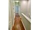 Upstairs hallway with wood floors and neutral paint at 5864 Fishhawk Ridge Dr, Lithia, FL 33547