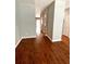 Hallway featuring dark stained hardwood floors, neutral walls and arched doorways at 5864 Fishhawk Ridge Dr, Lithia, FL 33547