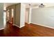 Hallway featuring dark stained hardwood floors, neutral walls and an ornate chandelier at 5864 Fishhawk Ridge Dr, Lithia, FL 33547