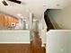 Open-concept living area with wood floors flowing into the adjacent kitchen and staircase at 5864 Fishhawk Ridge Dr, Lithia, FL 33547