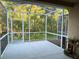 A screened patio looks out over lush trees and greenery in the backyard at 5864 Fishhawk Ridge Dr, Lithia, FL 33547