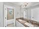 A bright bathroom with double sinks, granite countertops, a large mirror, and modern fixtures at 3027 W Spruce St, Tampa, FL 33607