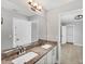A bright bathroom with double sinks, granite countertops, a large mirror, and modern fixtures at 3027 W Spruce St, Tampa, FL 33607
