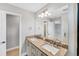 Modern bathroom featuring double sinks with granite countertops, a large mirror, and sleek fixtures, offering both style and functionality at 3027 W Spruce St, Tampa, FL 33607