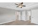 Bedroom featuring a ceiling fan, and adjacent bathrooms, providing convenience and ample storage in a neutral, airy space at 3027 W Spruce St, Tampa, FL 33607