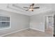 Inviting bedroom with large window, ceiling fan and neutral decor providing a serene and airy atmosphere in the home at 3027 W Spruce St, Tampa, FL 33607