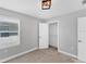 A bright bedroom features a neutral palette, window, walk-in closet and a simple light fixture at 3027 W Spruce St, Tampa, FL 33607