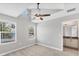 Bright bedroom featuring a ceiling fan, neutral palette, and a bathroom at 3027 W Spruce St, Tampa, FL 33607