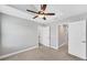 A bright bedroom features a ceiling fan, neutral palette, and a closet at 3027 W Spruce St, Tampa, FL 33607