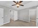 A bright bedroom features a ceiling fan, neutral palette, and multiple closets at 3027 W Spruce St, Tampa, FL 33607