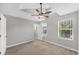 Bright bedroom features a ceiling fan, neutral palette, and natural light from the window at 3027 W Spruce St, Tampa, FL 33607