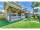 Attractive home featuring a cozy front porch and artificial green grass at 3027 W Spruce St, Tampa, FL 33607
