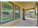 Close-up of the covered front porch with view of the street and neighboring homes at 3027 W Spruce St, Tampa, FL 33607