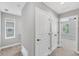 Well-lit hallway with neutral walls, carpet flooring, and white doors leading to various rooms, enhancing the home's flow at 3027 W Spruce St, Tampa, FL 33607