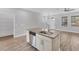 Kitchen island with sink and dishwasher; open to dining and living areas at 3027 W Spruce St, Tampa, FL 33607