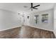 Open-concept living room with wood-look floors, neutral walls, and ample natural light at 3027 W Spruce St, Tampa, FL 33607