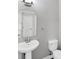 Pedestal sink and oval mirror in a well-lit half bath at 3027 W Spruce St, Tampa, FL 33607
