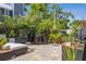 Inviting brick patio with black wicker furniture and lush landscaping at 3404 W Villa Rosa St, Tampa, FL 33611