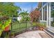Beautiful backyard view with lush gardens, manicured lawn, and charming fence at 3404 W Villa Rosa St, Tampa, FL 33611