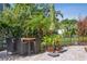 Charming patio with outdoor dining set surrounded by lush tropical plants and a green umbrella at 3404 W Villa Rosa St, Tampa, FL 33611