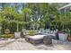 Backyard patio features a stone surface, comfortable patio furniture and lush, tropical foliage at 3404 W Villa Rosa St, Tampa, FL 33611
