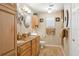 Bathroom features double sinks, wooden cabinets, tan walls, tiled floor, and a glass door shower at 3404 W Villa Rosa St, Tampa, FL 33611