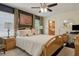 Bedroom with dark accent wall, bathroom access, king bed with decorative pillows, and two side tables at 3404 W Villa Rosa St, Tampa, FL 33611