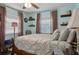 Comfortable bedroom with light blue walls, ceiling fan, and plenty of pillows on the bed at 3404 W Villa Rosa St, Tampa, FL 33611