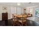 Cozy dining room with hardwood floors, an ornate light fixture and beautiful furnishings at 3404 W Villa Rosa St, Tampa, FL 33611